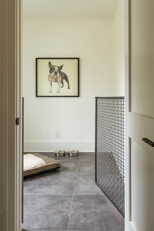 Dog room separated from the rest of the house with a metal, swinging gate 