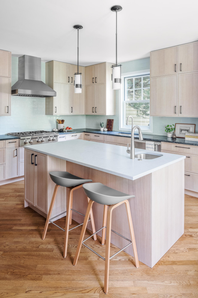 Eat-in kitchen - mid-sized contemporary l-shaped medium tone wood floor and brown floor eat-in kitchen idea in DC Metro with an undermount sink, shaker cabinets, light wood cabinets, blue backsplash, subway tile backsplash, stainless steel appliances, an island and white countertops