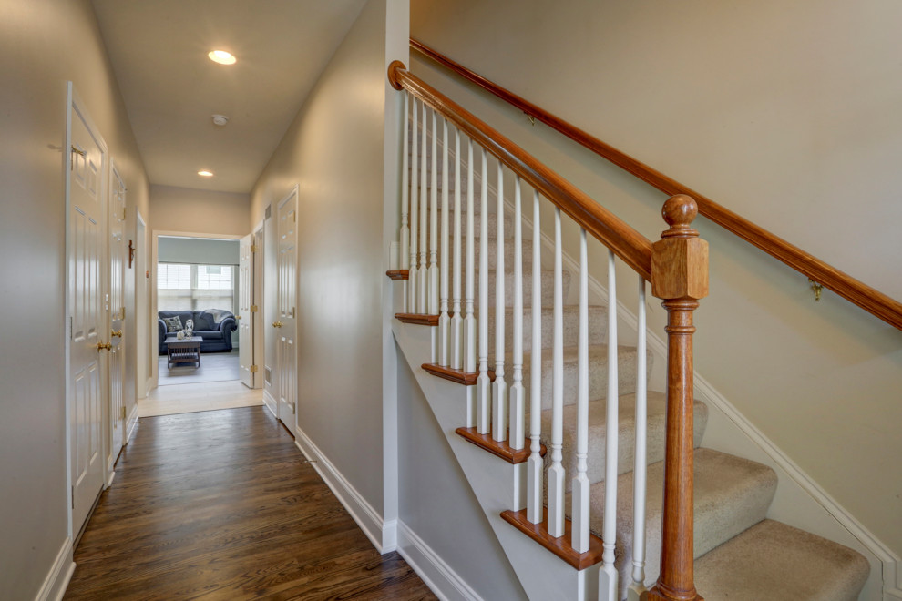 Example of a mid-sized transitional vinyl floor and brown floor entry hall design with gray walls
