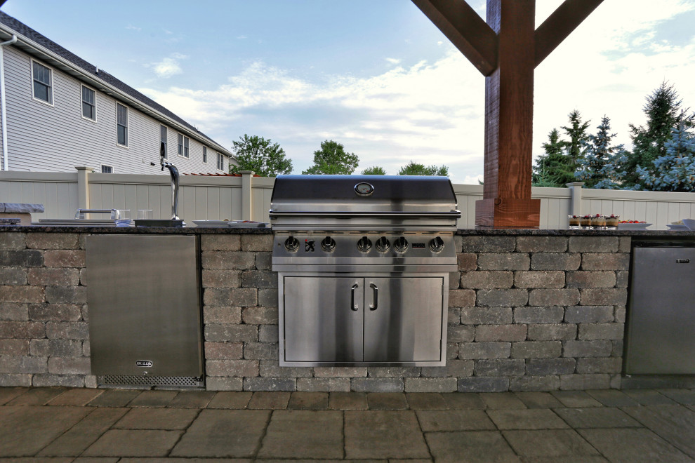 Photo of a mid-sized rustic privacy and full sun backyard stone landscaping.
