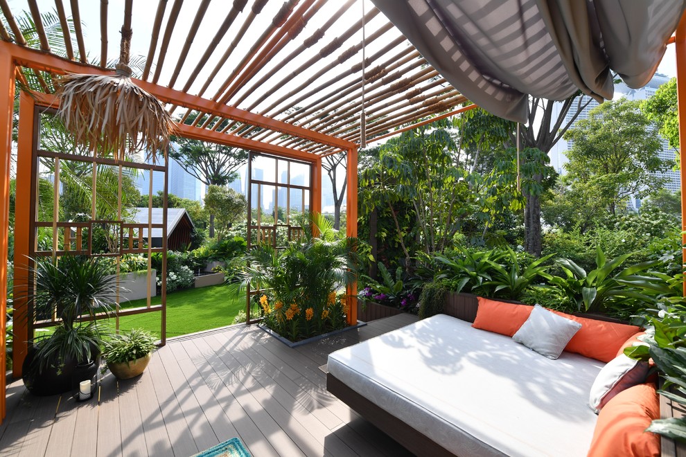 Inspiration for an asian backyard deck in Hertfordshire with a pergola.