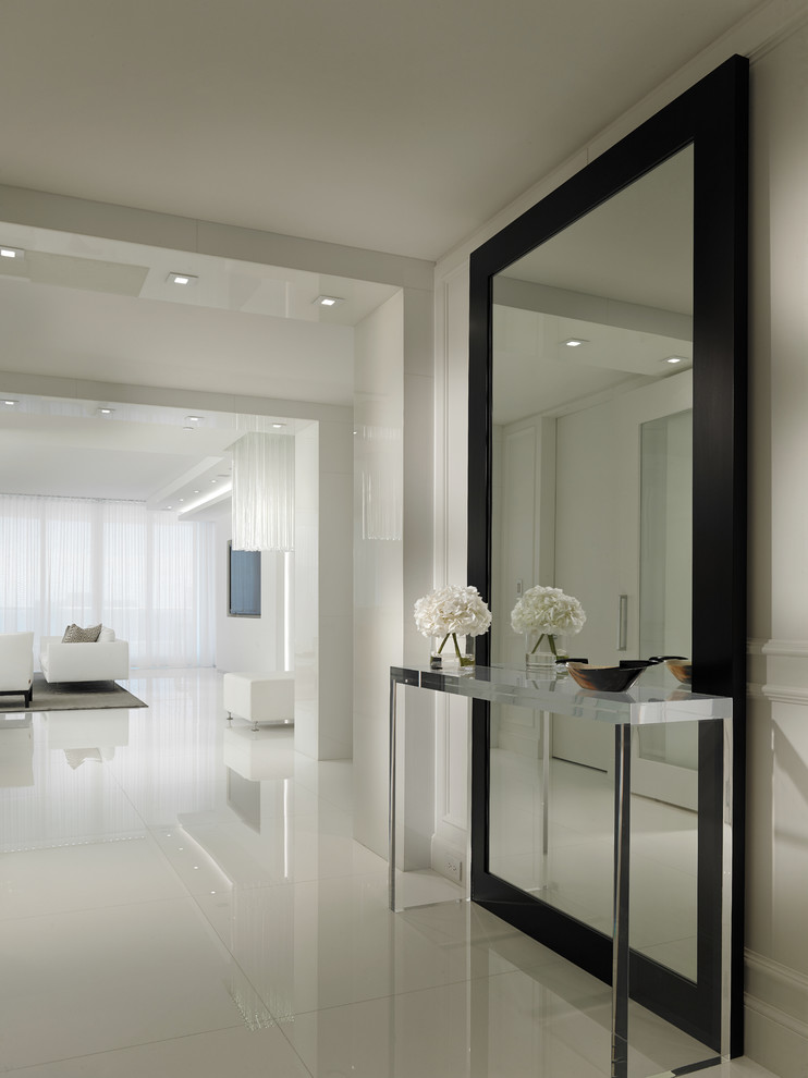 This is an example of a contemporary hallway in Miami with white walls and white floor.
