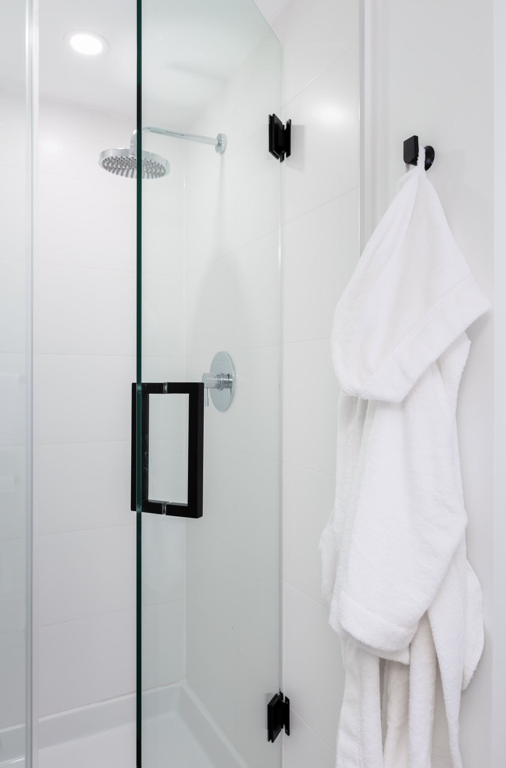 Glass shower with robe hooks