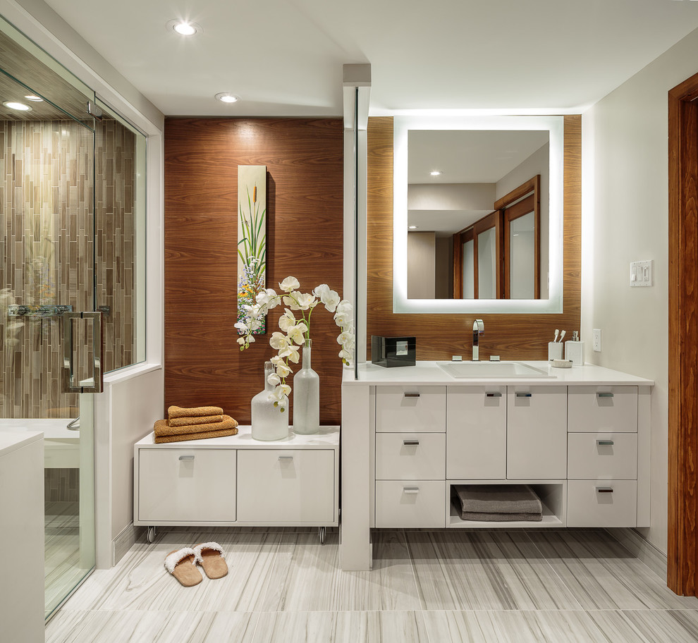 Inspiration for a mid-sized contemporary master bathroom in Ottawa with a drop-in sink, flat-panel cabinets, white cabinets, an alcove shower, brown tile, mosaic tile, white walls, porcelain floors, engineered quartz benchtops, grey floor and a hinged shower door.