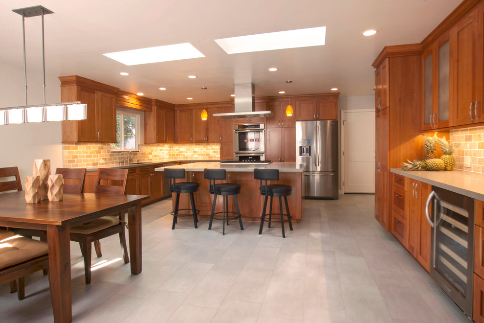 Eat-in kitchen - large transitional u-shaped eat-in kitchen idea in San Francisco with shaker cabinets, medium tone wood cabinets, quartz countertops, ceramic backsplash, stainless steel appliances and an island