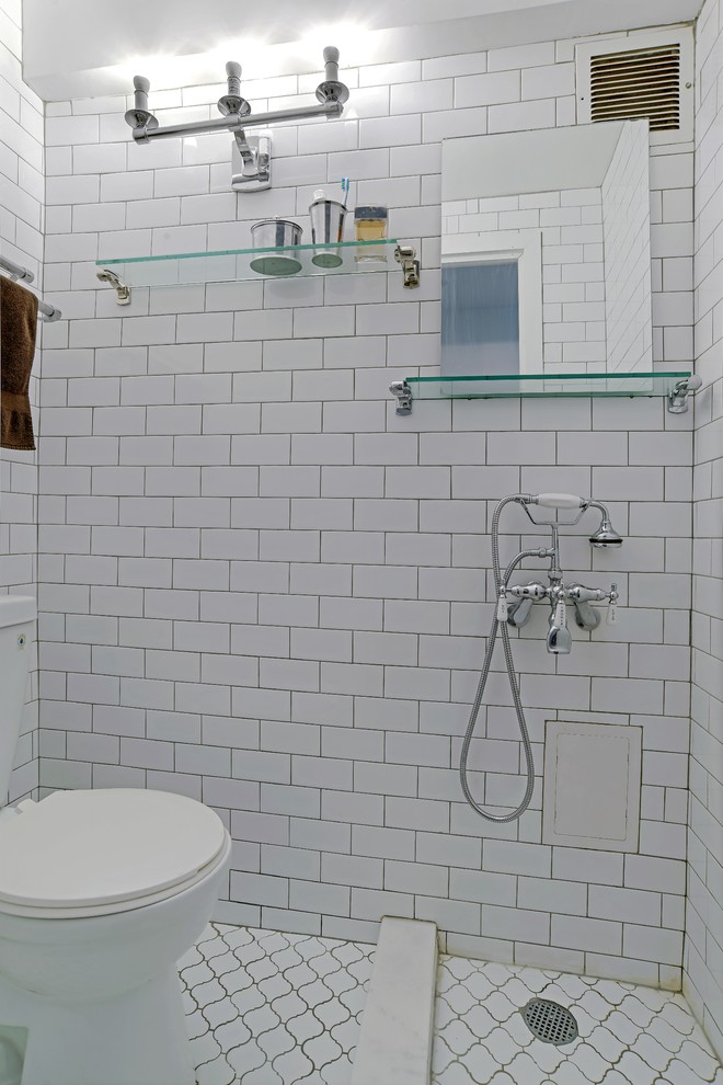 Inspiration for a small contemporary 3/4 wet room bathroom in New York with a two-piece toilet, white tile, ceramic tile, ceramic floors, a wall-mount sink, glass benchtops, white floor and an open shower.