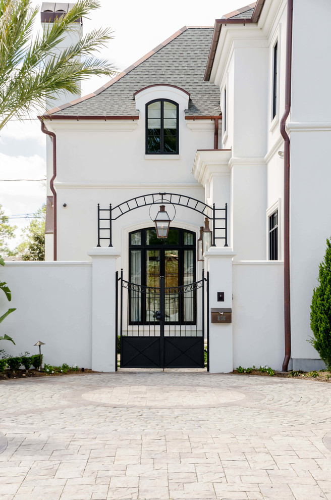 This is an example of a large traditional two-storey stucco white exterior in New Orleans.