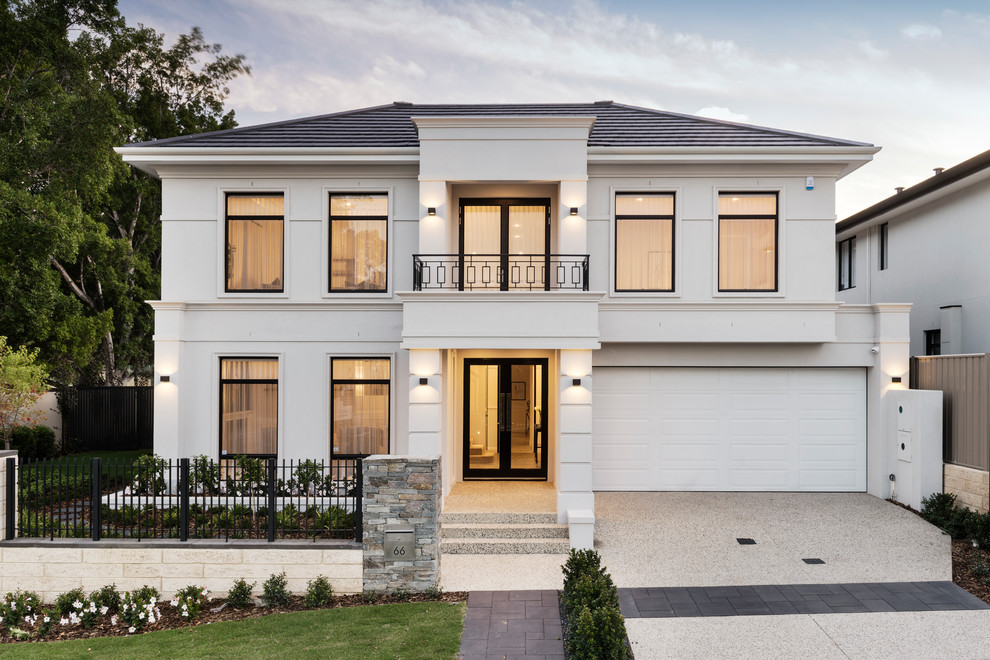 This is an example of a transitional two-storey white house exterior in Perth with a hip roof and a shingle roof.