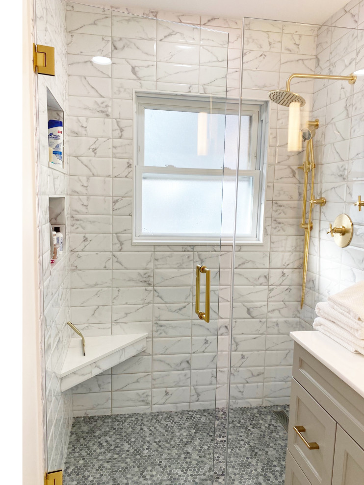 This is an example of a small contemporary master bathroom in Chicago with grey cabinets, an alcove shower, gray tile, a hinged shower door, white benchtops, a single vanity and a freestanding vanity.