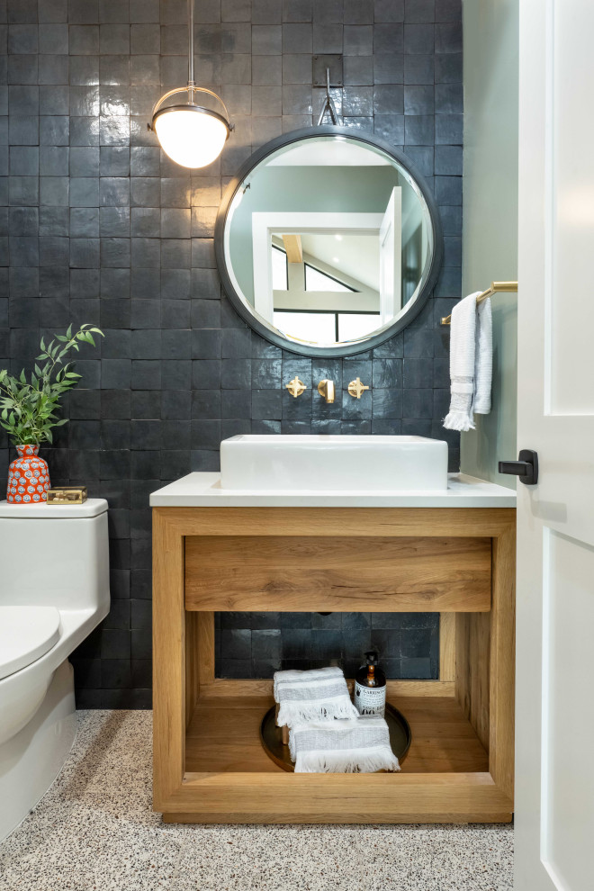 Small transitional black tile and terra-cotta tile cement tile floor and brown floor powder room photo in San Francisco with open cabinets, medium tone wood cabinets, a one-piece toilet, green walls, quartz countertops, white countertops and a freestanding vanity