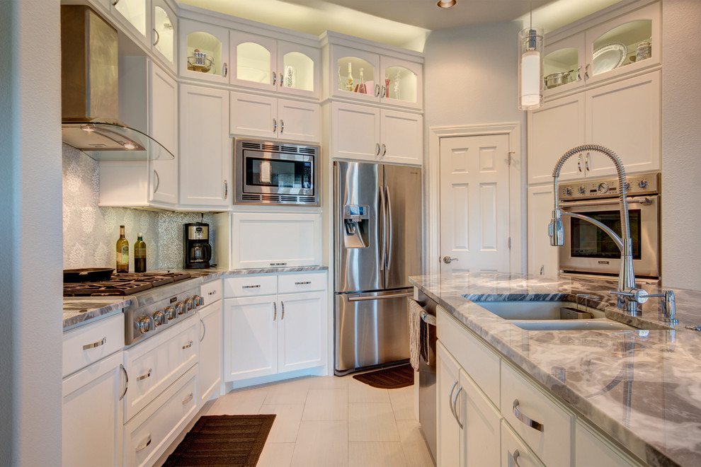 Eat-in kitchen - large transitional u-shaped porcelain tile eat-in kitchen idea in Austin with an undermount sink, recessed-panel cabinets, white cabinets, marble countertops, gray backsplash, mosaic tile backsplash, stainless steel appliances and an island