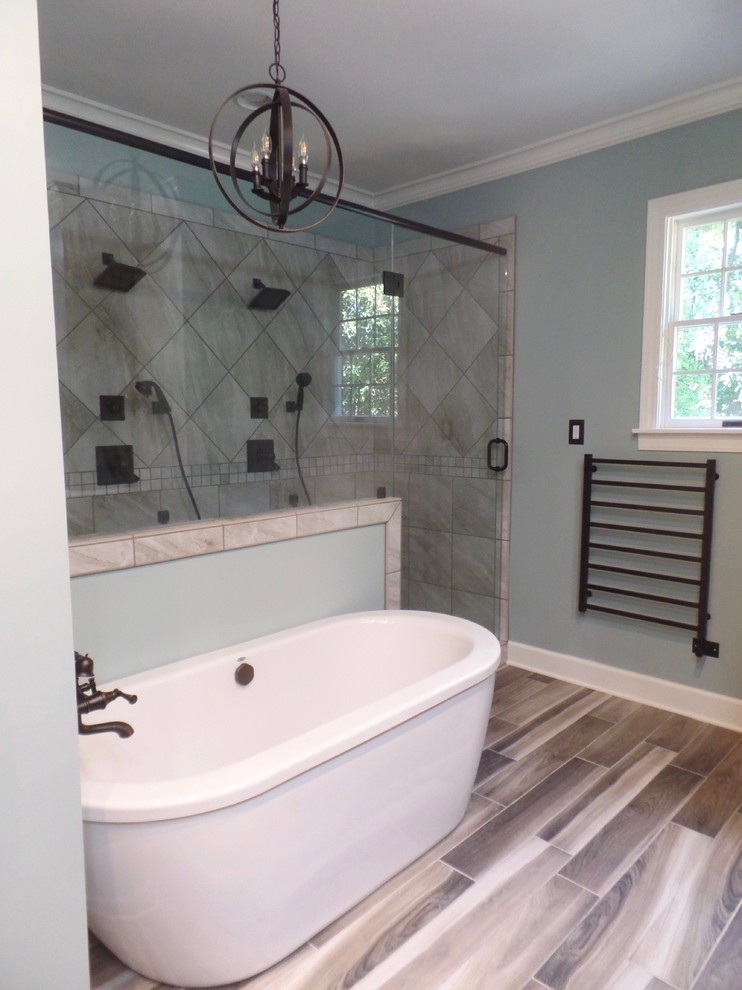 Mid-sized transitional master bathroom in Other with shaker cabinets, distressed cabinets, a freestanding tub, a double shower, a two-piece toilet, gray tile, porcelain tile, green walls, porcelain floors, an undermount sink and engineered quartz benchtops.