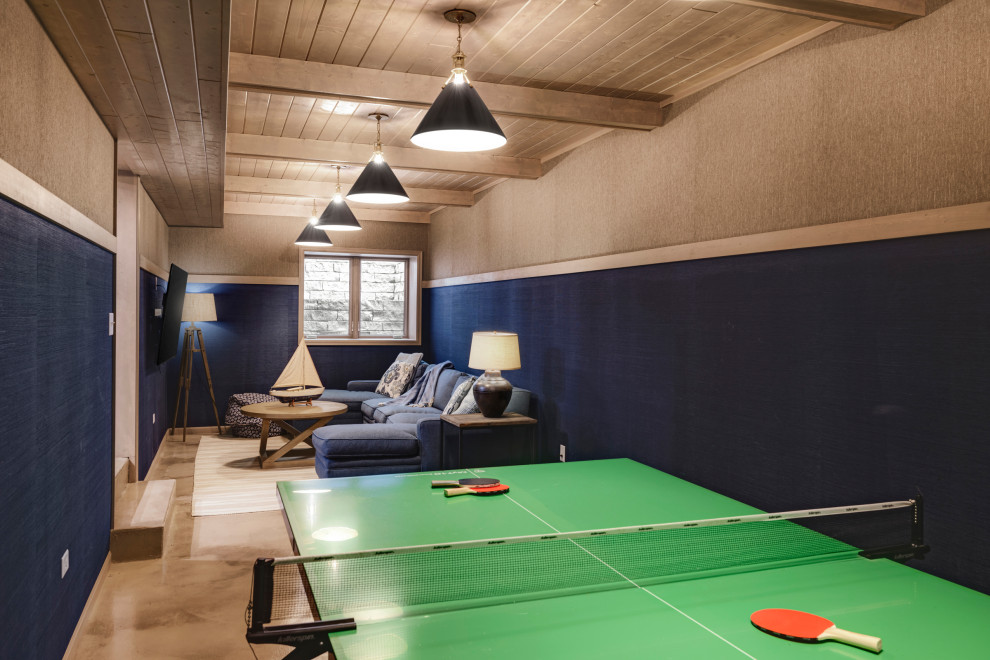 Inspiration for a large enclosed family room in Minneapolis with a game room, blue walls, concrete floors, a wall-mounted tv, beige floor, exposed beam and wallpaper.