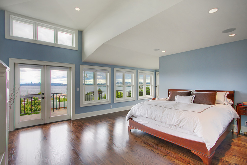 This is an example of a traditional bedroom in Seattle with blue walls and medium hardwood floors.