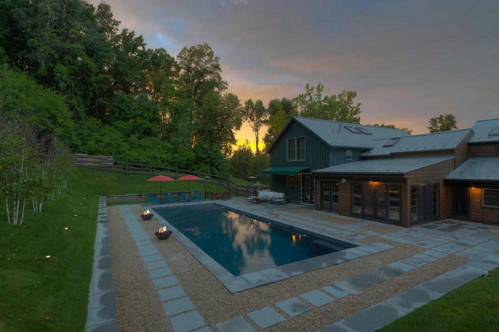 Inspiration for a mid-sized rustic backyard stone and rectangular lap pool remodel in New York