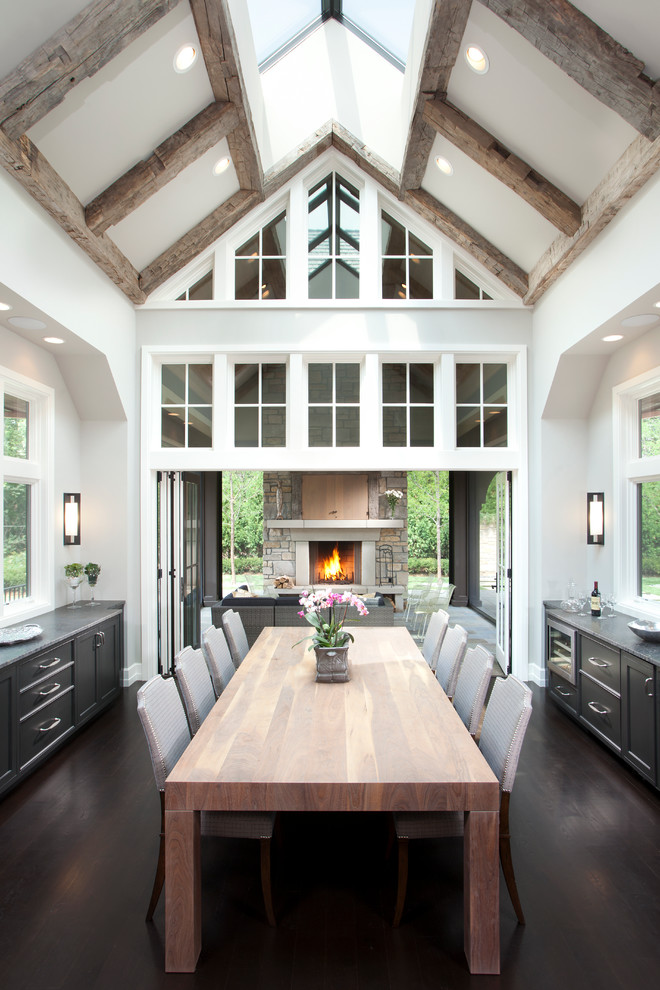 Design ideas for a transitional kitchen/dining combo in Minneapolis with white walls and dark hardwood floors.