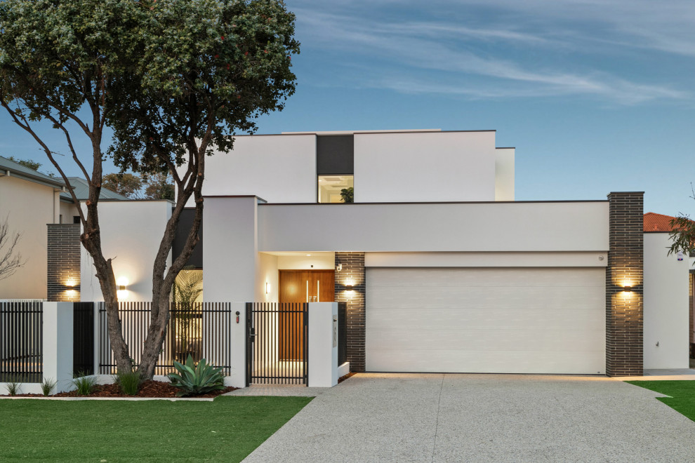 Design ideas for a contemporary two-storey white house exterior in Perth with a flat roof.