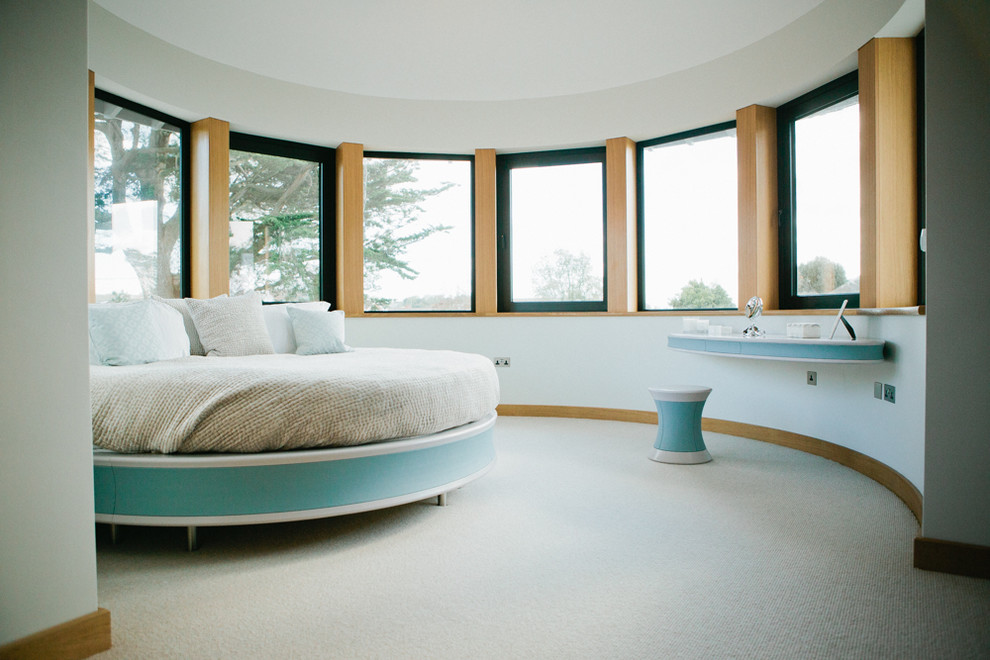 Design ideas for a contemporary bedroom in Devon with white walls and carpet.