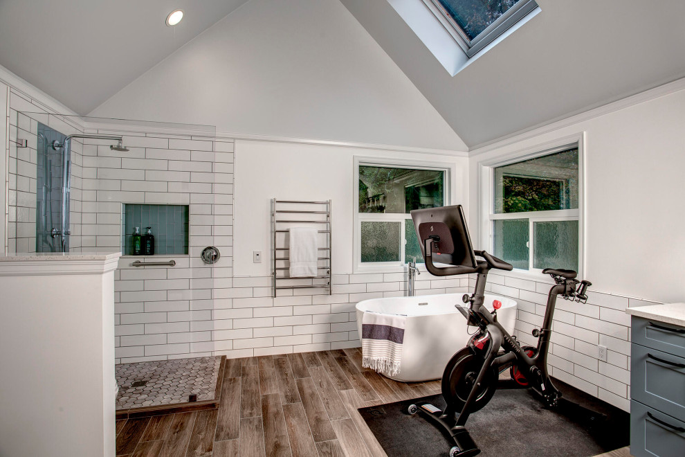 Large transitional home gym in Seattle with white walls, porcelain floors, brown floor and vaulted.