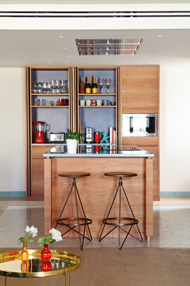 Inspiration for a mid-sized contemporary galley seated home bar in Valencia with open cabinets, medium wood cabinets, ceramic floors, blue splashback and no sink.