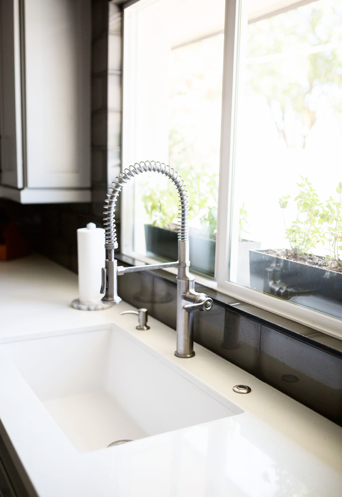 Mid-sized transitional u-shaped light wood floor and gray floor eat-in kitchen photo in Phoenix with an undermount sink, recessed-panel cabinets, gray cabinets, quartz countertops, multicolored backsplash, ceramic backsplash, stainless steel appliances, an island and white countertops