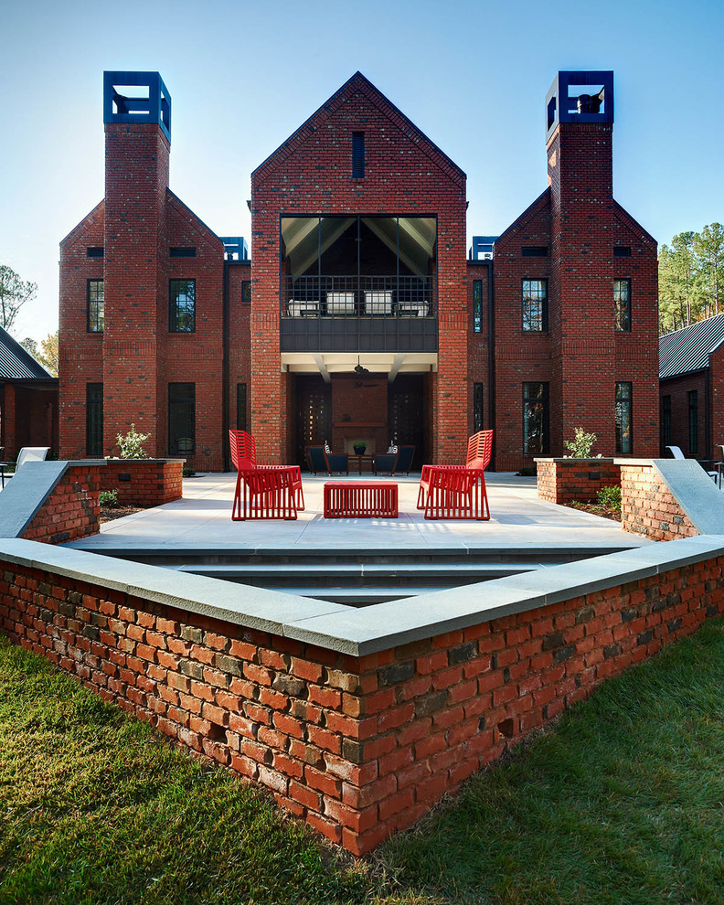 Transitional two-storey brick exterior in Raleigh with a gable roof.