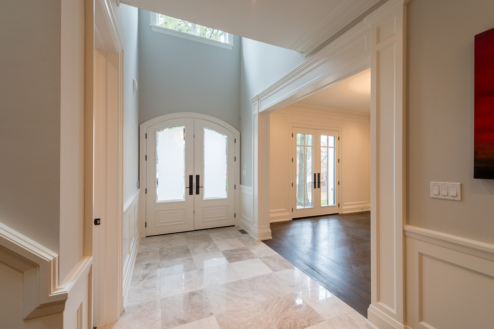 Photo of a transitional entryway in Toronto with a double front door.