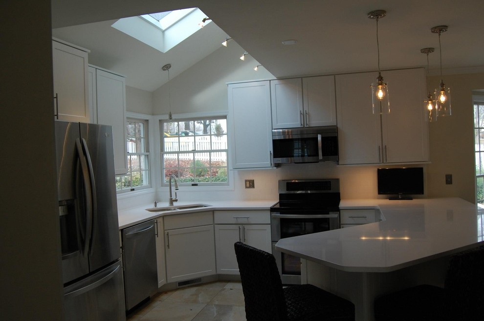 Example of a small transitional u-shaped ceramic tile and beige floor open concept kitchen design in St Louis with a double-bowl sink, shaker cabinets, white cabinets, quartz countertops, stainless steel appliances, a peninsula and white countertops
