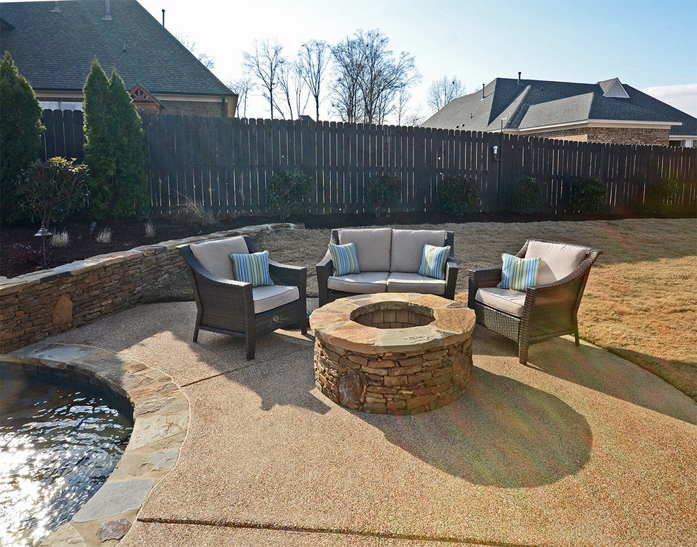 Large island style backyard concrete and custom-shaped lap pool fountain photo