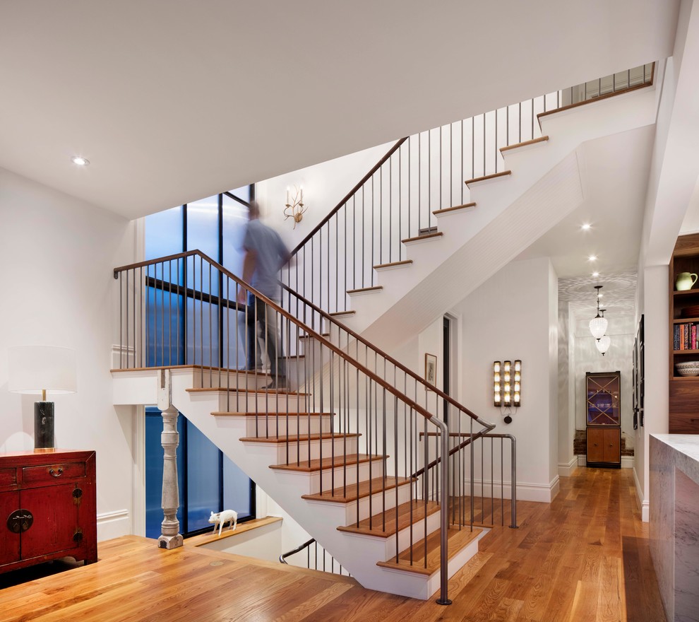 Inspiration for a mid-sized transitional wooden u-shaped staircase remodel in Denver with painted risers