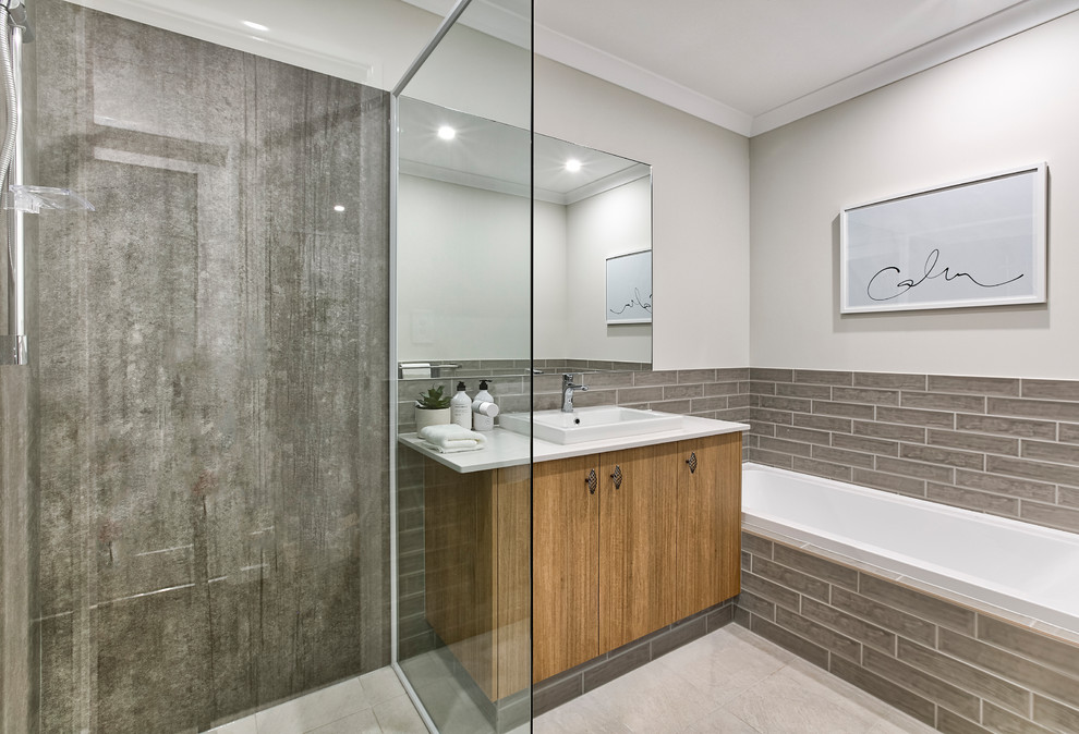 Inspiration for a mid-sized contemporary master bathroom in Perth with a corner shower, brown tile, white walls, beige floor, a hinged shower door, white benchtops, flat-panel cabinets, medium wood cabinets, a drop-in tub and a drop-in sink.