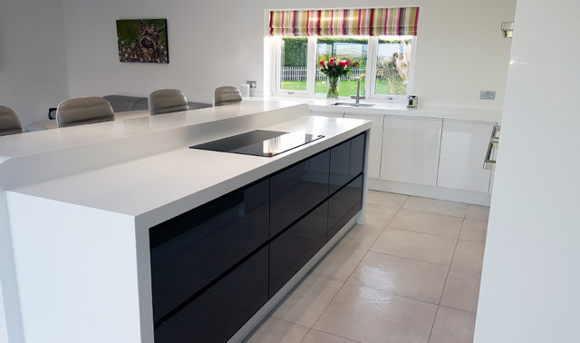 A Metz Gloss White And Gloss Graphite Kitchen With Corian Worktops