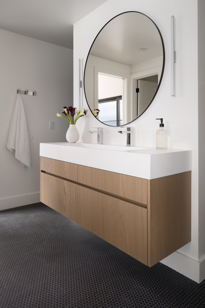 Modern kids bathroom in Denver with flat-panel cabinets, light wood cabinets, white tile, ceramic tile, white walls, mosaic tile floors, an integrated sink, black floor, white benchtops, a double vanity and a floating vanity.