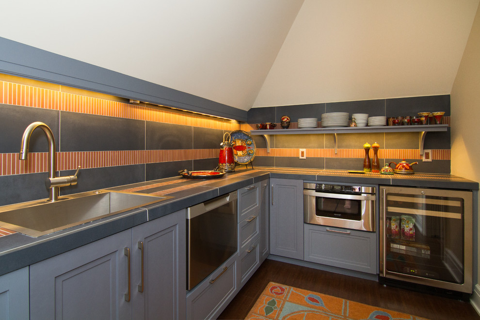 This is an example of a small traditional galley separate kitchen in Minneapolis with beaded inset cabinets, stainless steel appliances, a single-bowl sink, grey cabinets, tile benchtops, matchstick tile splashback and ceramic floors.