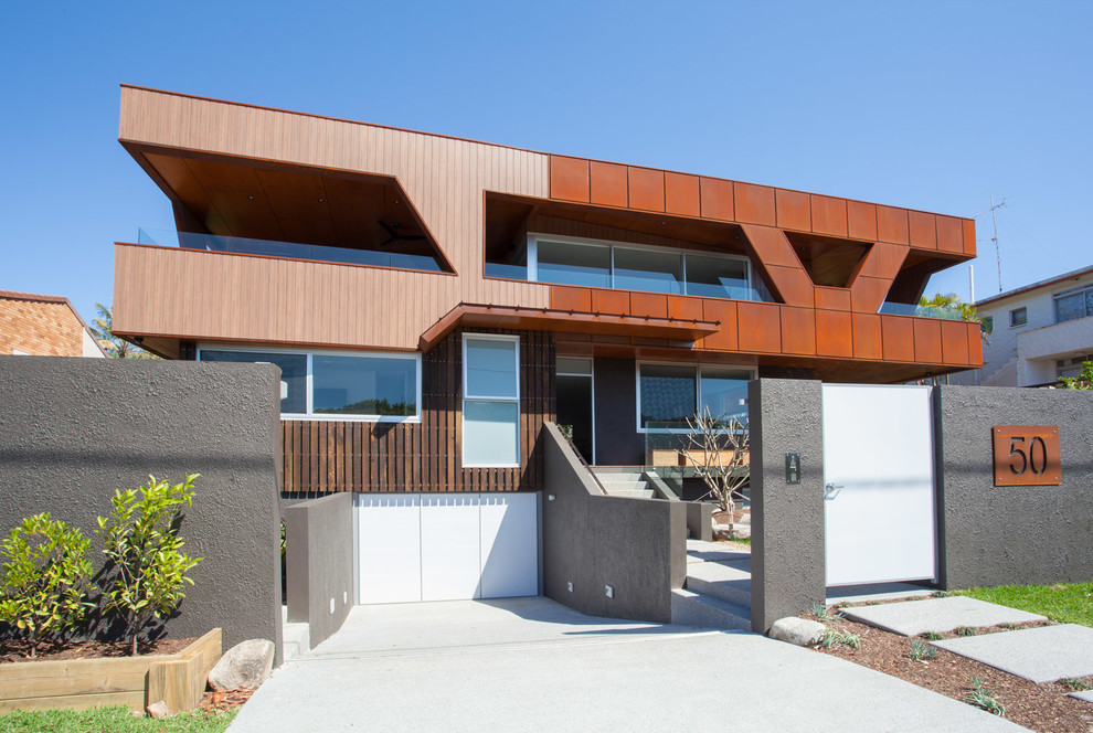 Design ideas for a contemporary two-storey exterior in Sunshine Coast with mixed siding and a flat roof.