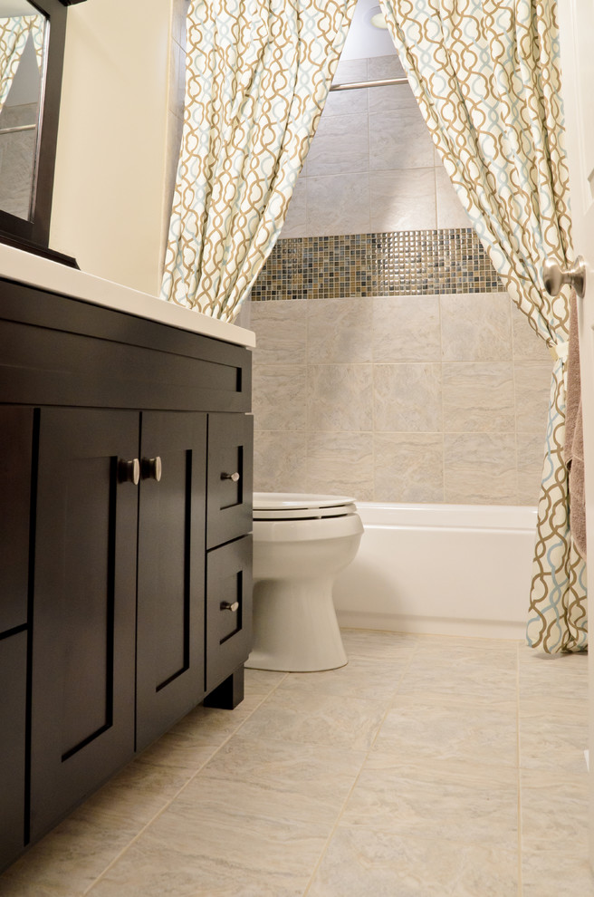 Small transitional beige tile porcelain tile tub/shower combo photo in Chicago with shaker cabinets, dark wood cabinets and beige walls