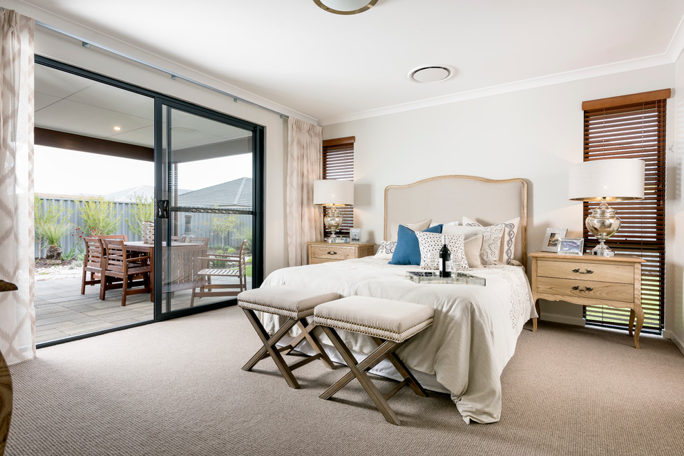 Photo of a mid-sized transitional master bedroom in Perth with beige walls and carpet.