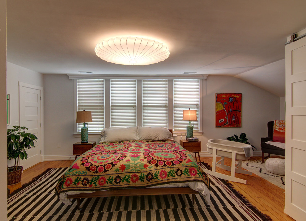 Design ideas for an eclectic bedroom in DC Metro with grey walls and medium hardwood floors.