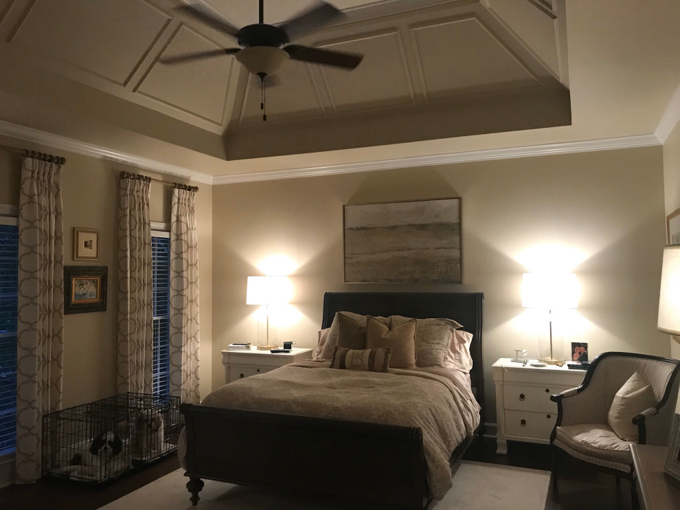 This is an example of a mid-sized transitional master bedroom with beige walls, dark hardwood floors, brown floor and vaulted.