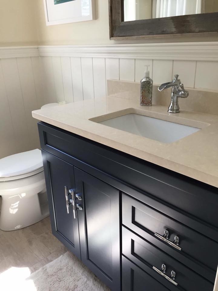 Mid-sized transitional 3/4 bathroom in Boston with shaker cabinets, beige cabinets, an alcove tub, a shower/bathtub combo, a two-piece toilet, beige walls, porcelain floors, an undermount sink, limestone benchtops, beige floor and a shower curtain.