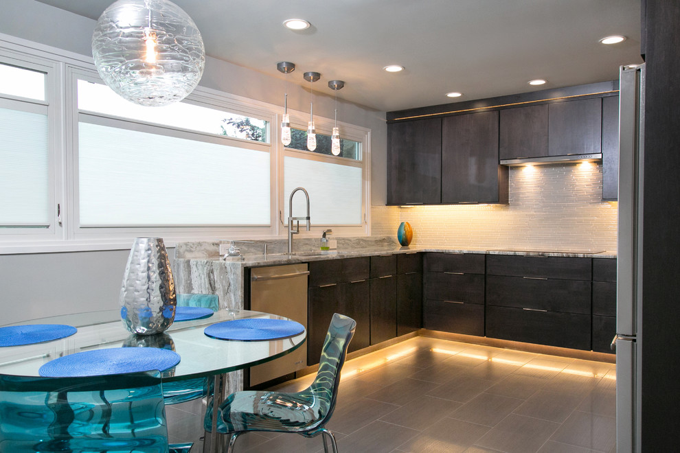 Example of a small minimalist u-shaped porcelain tile and brown floor enclosed kitchen design in Philadelphia with an undermount sink, flat-panel cabinets, dark wood cabinets, quartzite countertops, white backsplash, glass tile backsplash and stainless steel appliances
