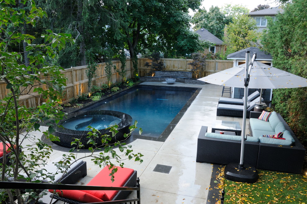Inspiration for a mid-sized transitional backyard rectangular pool remodel in Toronto with decking