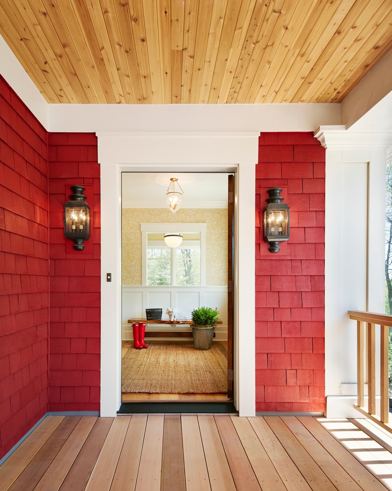 Inspiration for a mid-sized country front door in Minneapolis with red walls, a single front door, a medium wood front door and light hardwood floors.