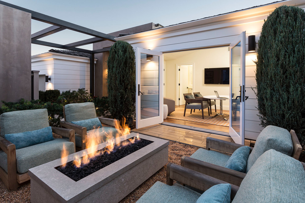 Photo of a contemporary backyard patio in Boise with a fire feature, gravel and no cover.
