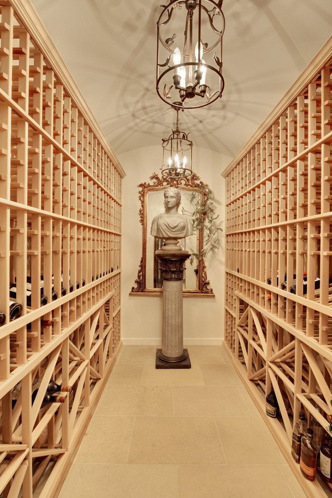 This is an example of a mediterranean wine cellar in Minneapolis with storage racks and beige floor.