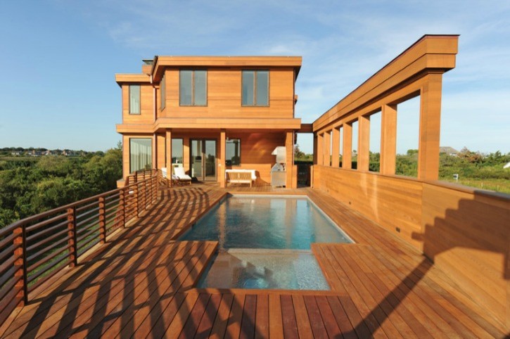 This is an example of a large contemporary rooftop rectangular lap pool with decking.