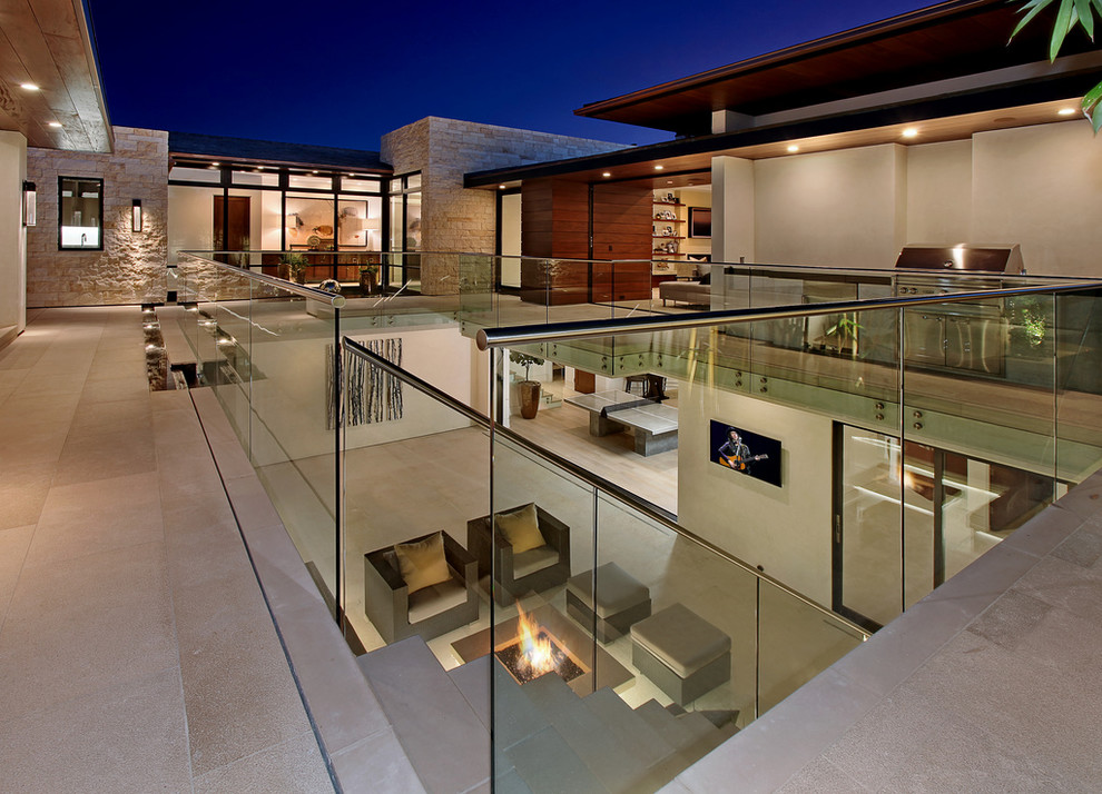 Inspiration for a contemporary courtyard patio in Orange County with a fire feature.