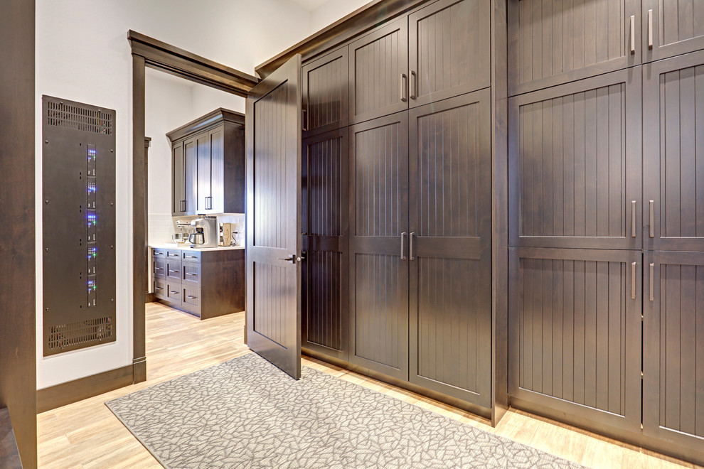 Inspiration for a transitional porcelain tile mudroom remodel in Calgary with white walls