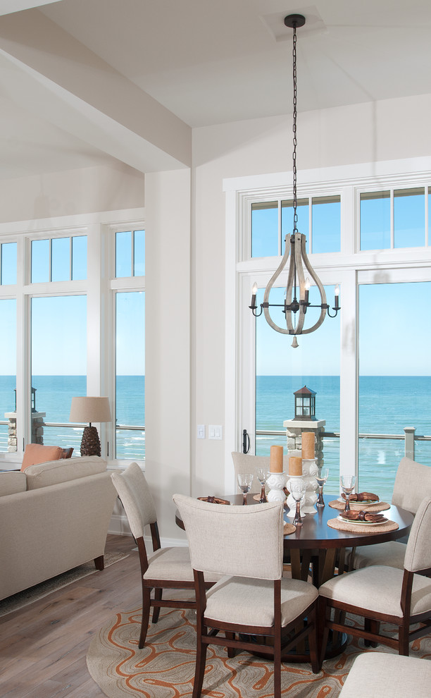 This is an example of a beach style dining room in Grand Rapids with grey walls and medium hardwood floors.