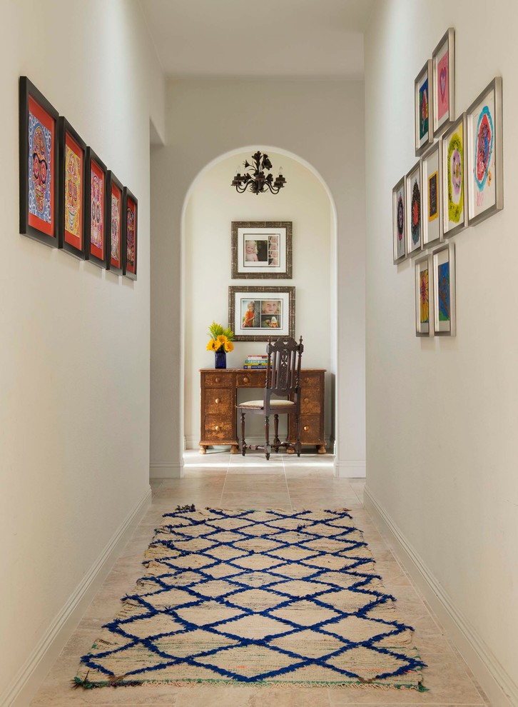 This is an example of a mid-sized traditional hallway in San Diego with white walls and ceramic floors.